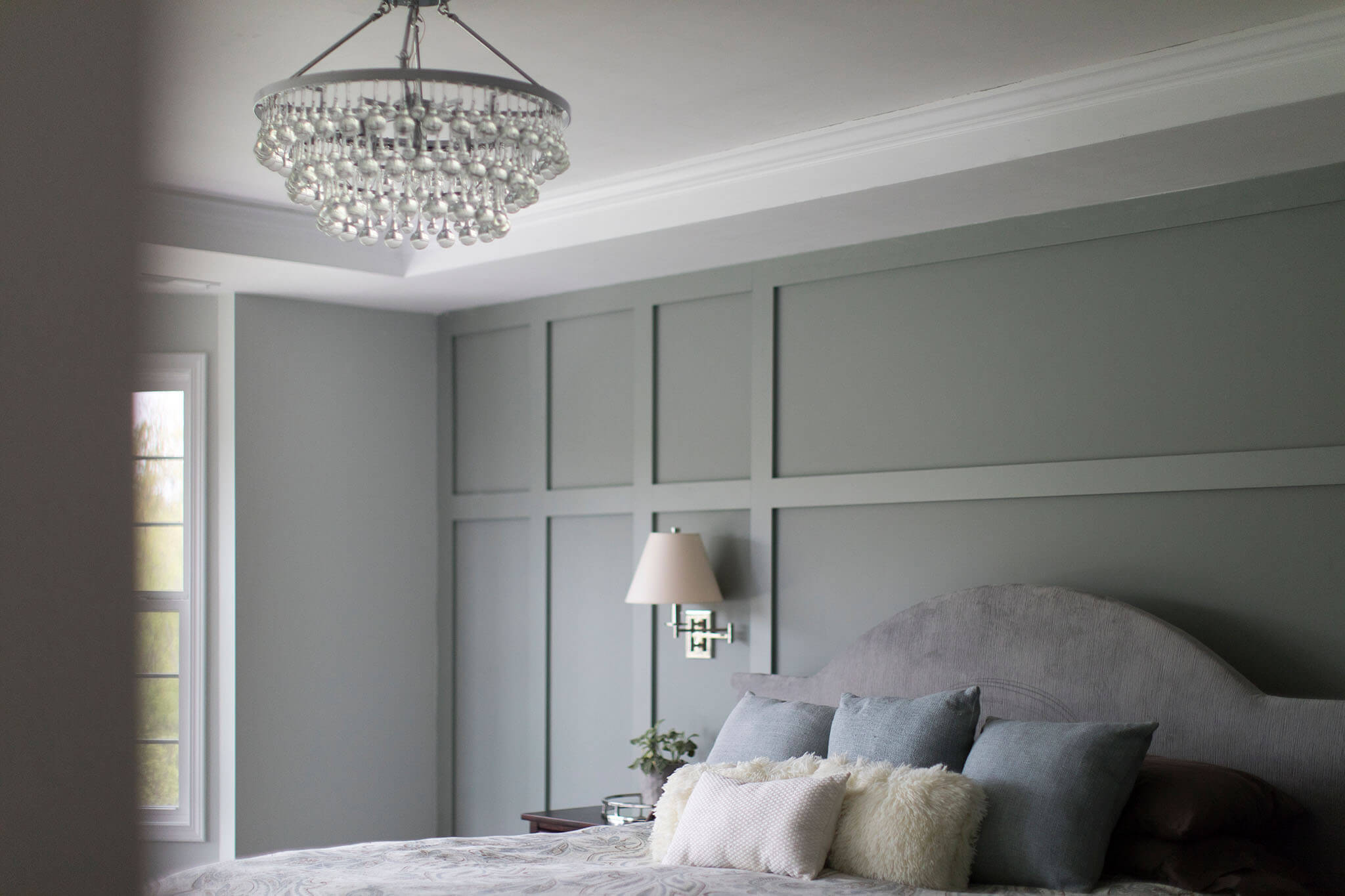 Master Bedroom after finishing touches - molding for interest on the feature wall, swing-arm sconces and chandelier. Lindsey Putzier Design Studio