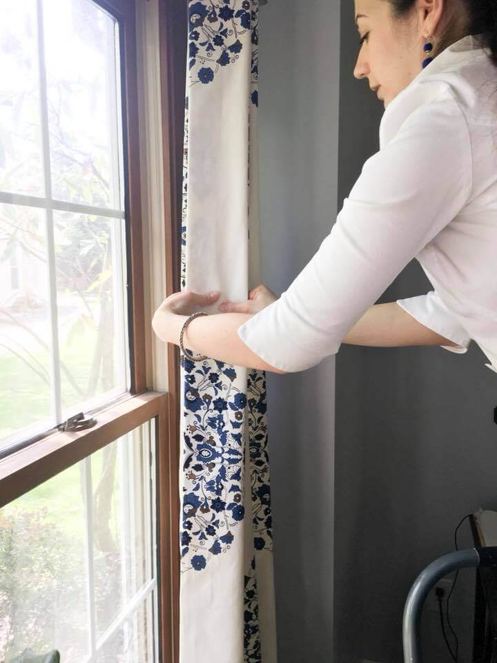 Lindsey Putzier demonstrating how to train ready-made draperies to hang properly Lindsey Putzier Design Studio