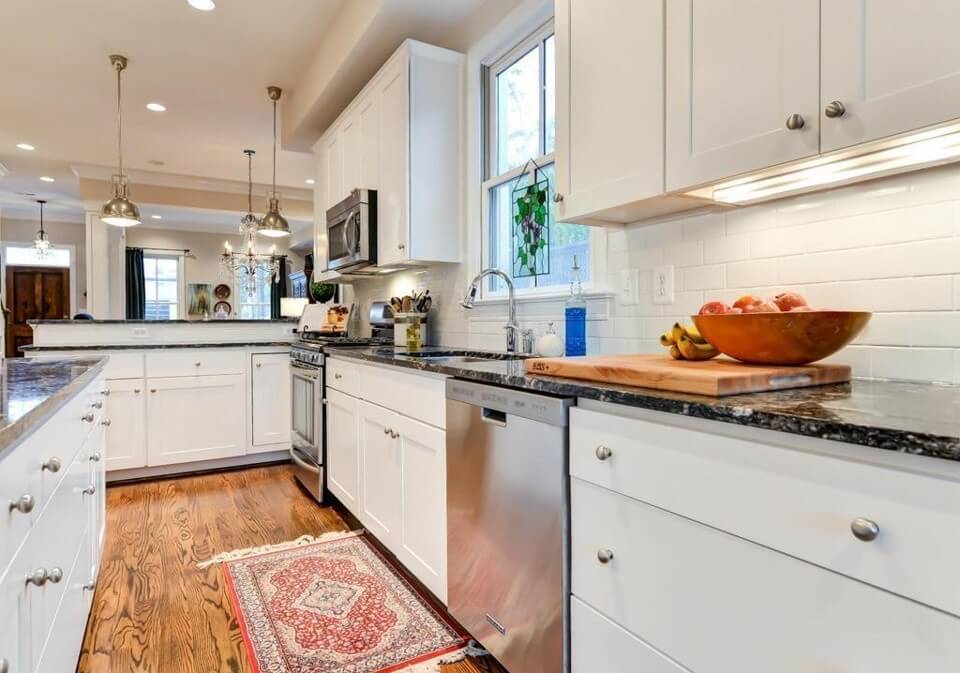 White Subway Backsplash Tile with Granite Counters in Kitchen Lindsey Putzier Design Studio