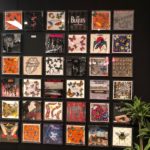 Artwork tiled wall with bands, famous brands, and more Lindsey Putzier Design Studio