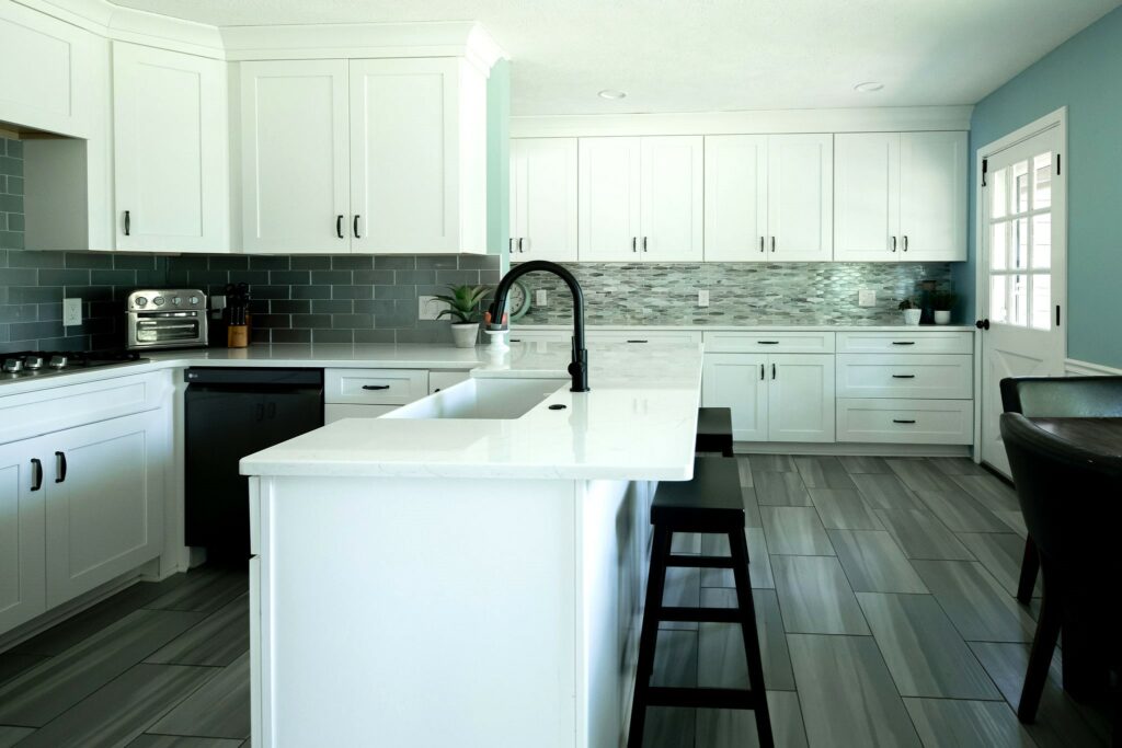 White cabinetry with black furniture in Northfield, OH Kitchen Design. Lindsey Putzier Design Studio