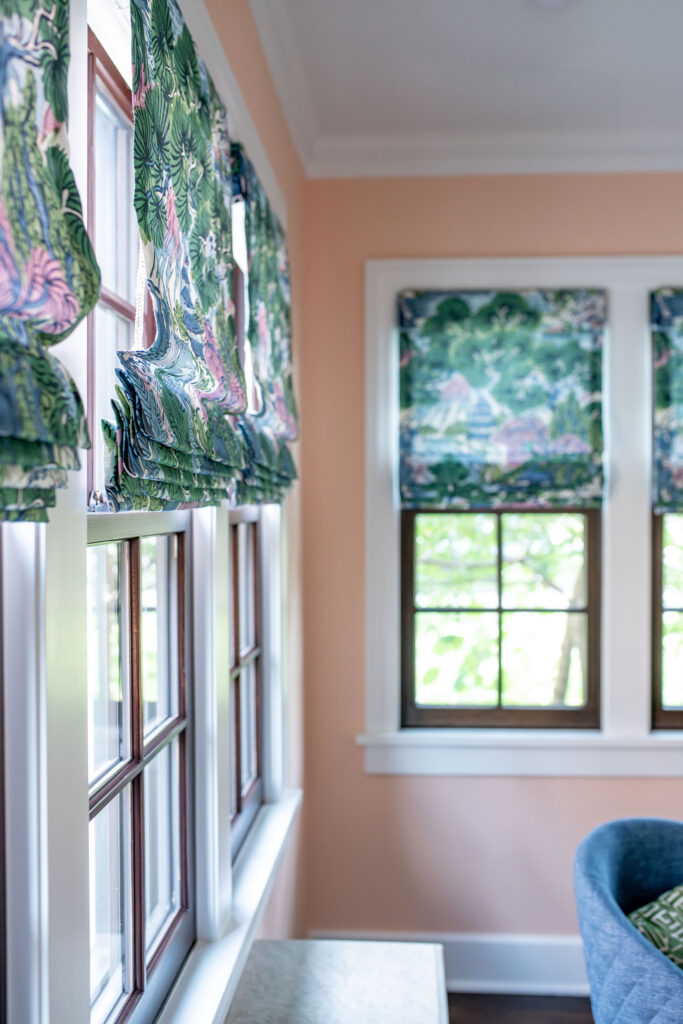 Custom window treatments in the sunroom with pattern and white trim windows. Shaker Heights Ohio interior design Lindsey Putzier
