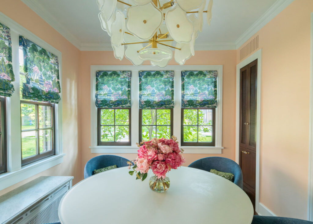 Sunroom refresh with custom colorful drapes and floral chandelier. Shaker Heights Ohio interior design Lindsey Putzier