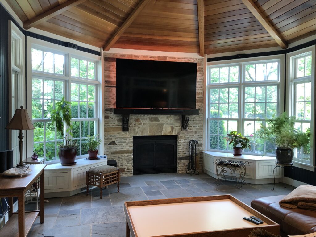 Before Sunroom image with large windows, fireplace, and wood ceiling