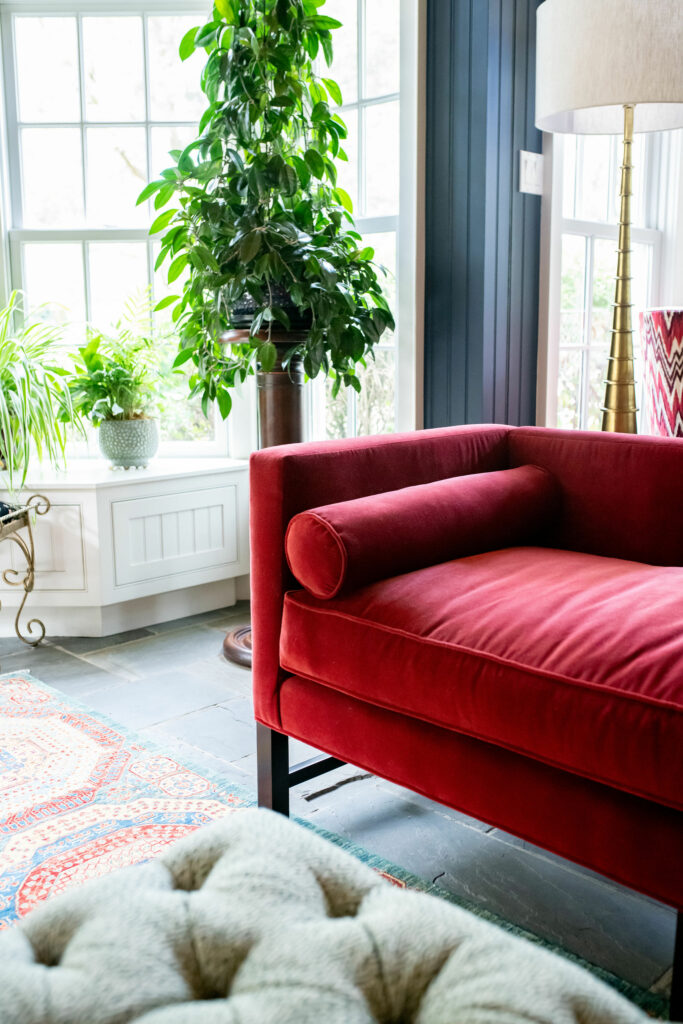 Red velvet day chaise in Sunroom Design Lindsey Putzier Design Studio Ohio