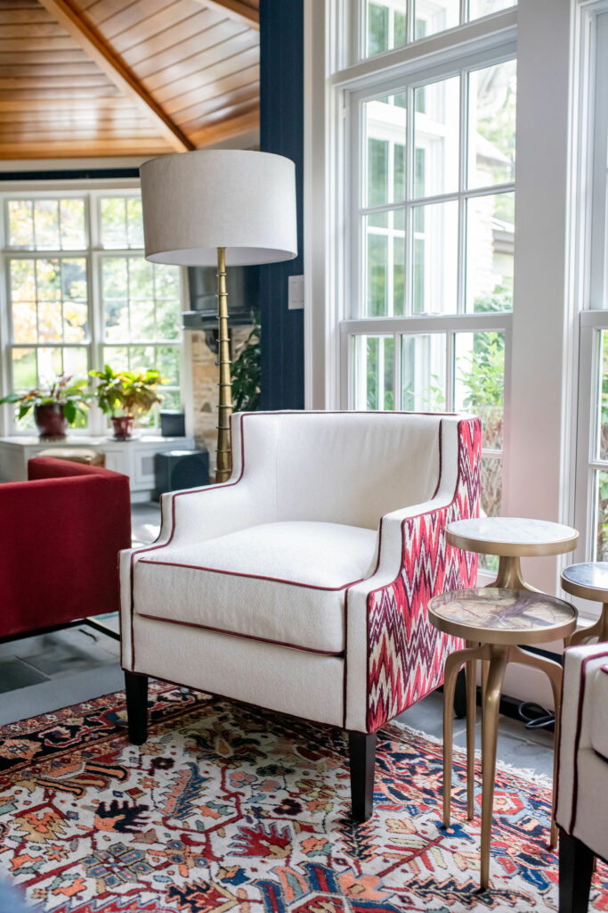 Low-back chairs with outside flamestitch velvet and inside cream fabric. Lindsey Putzier Sunroom Design