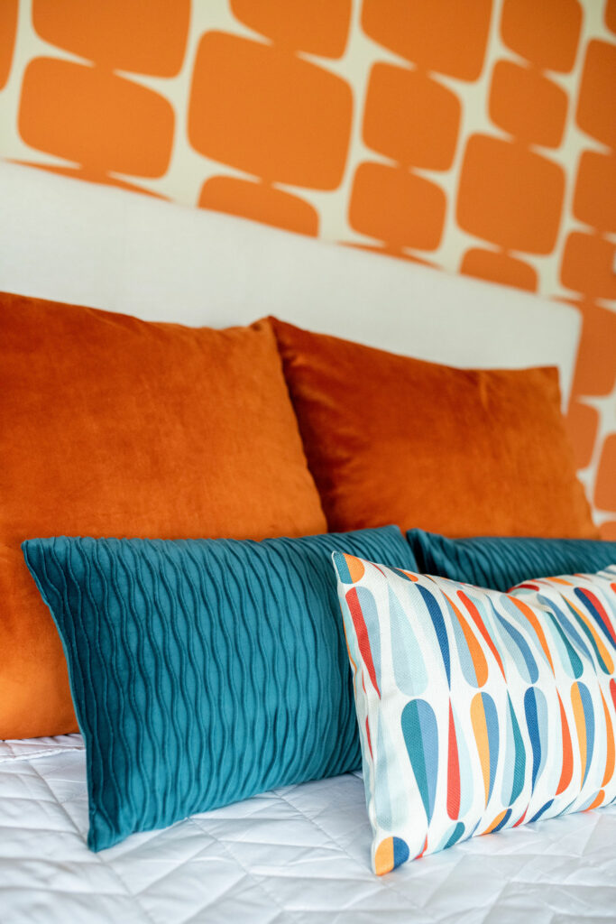 Master Bedroom pillows in orange, blue, and white patterned. Lindsey Putzier Design Studio Hudson, OH