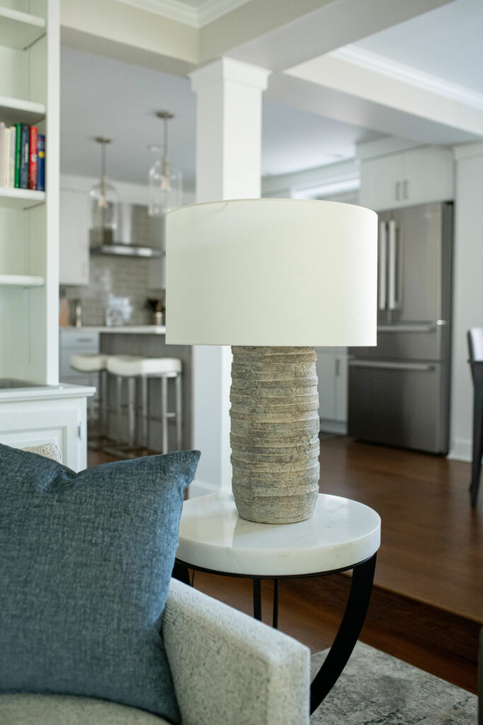 Flat discs of gray terracotta encircle a wrought iron spine on this table lamp with vanilla shade. Lindsey Putzier Ohio