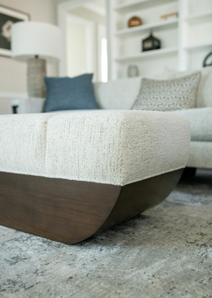 Sculptural ottoman with libby linen attached segmented seat and an ark shaped wood base Lindsey Putzier Ohio