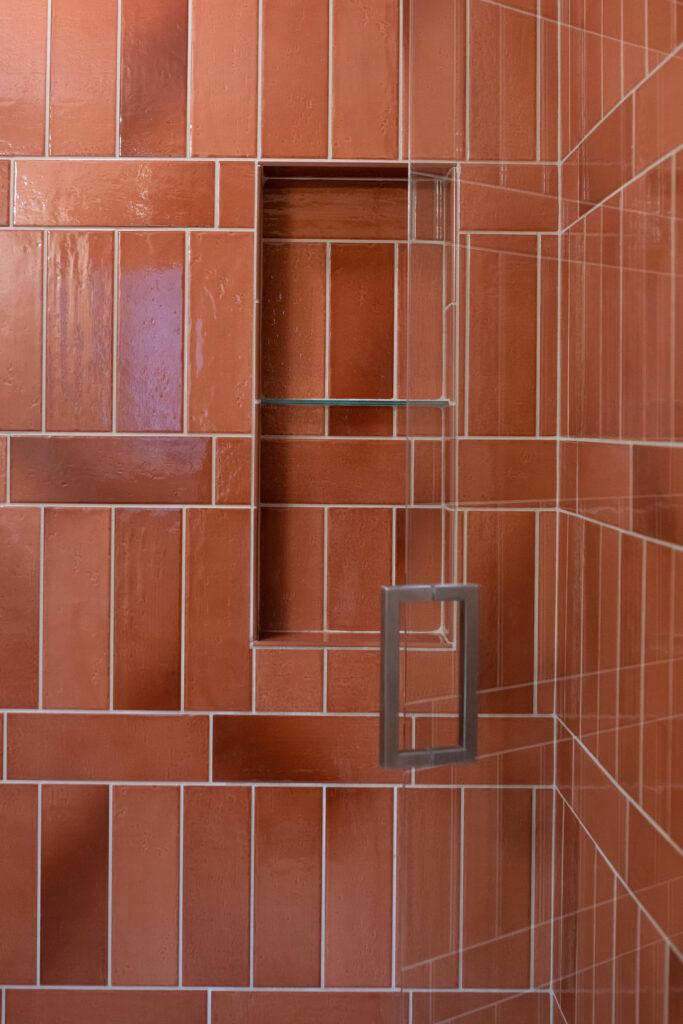 Orange tiled shower niche in Bathroom design Lindsey Putzier Design Studio Hudson, OH