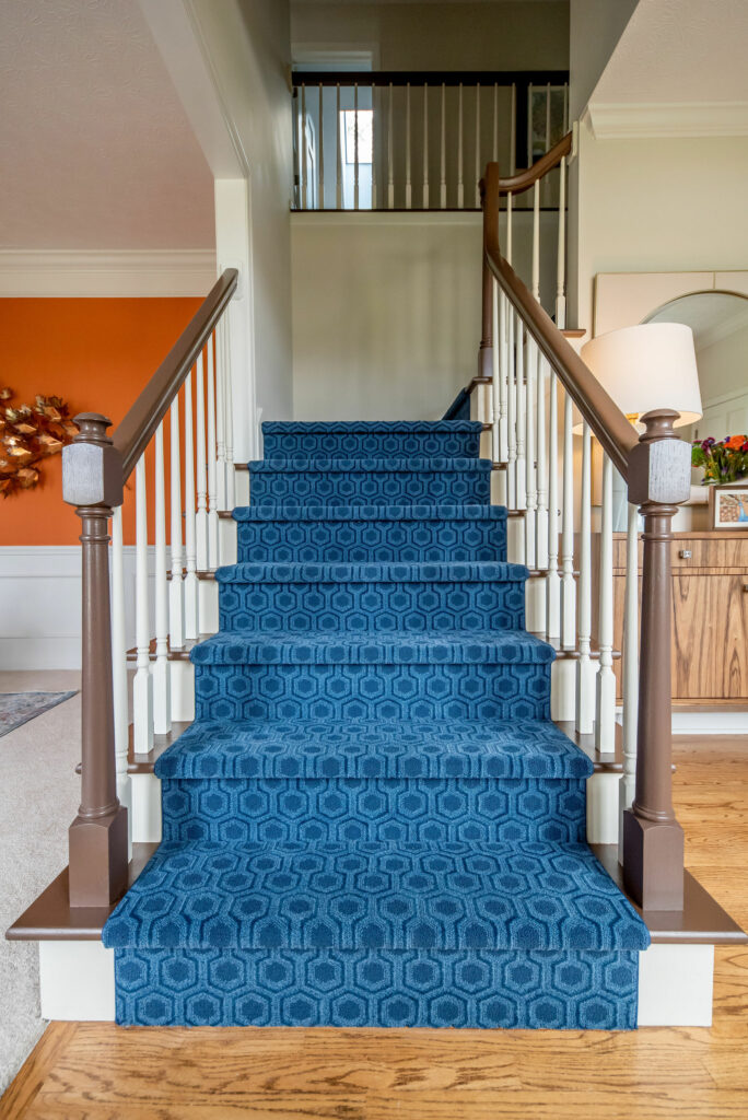 After image of Foyer stairs with blue geometric patterned carpeting. Lindsey Putzier Design Studio. Hudson, OH