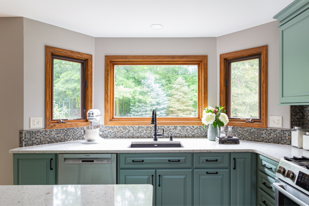 A large 18” trash pullout with two trash cans in Kitchen cabinetry. Lindsey Putzier Design Studio Hudson, OH