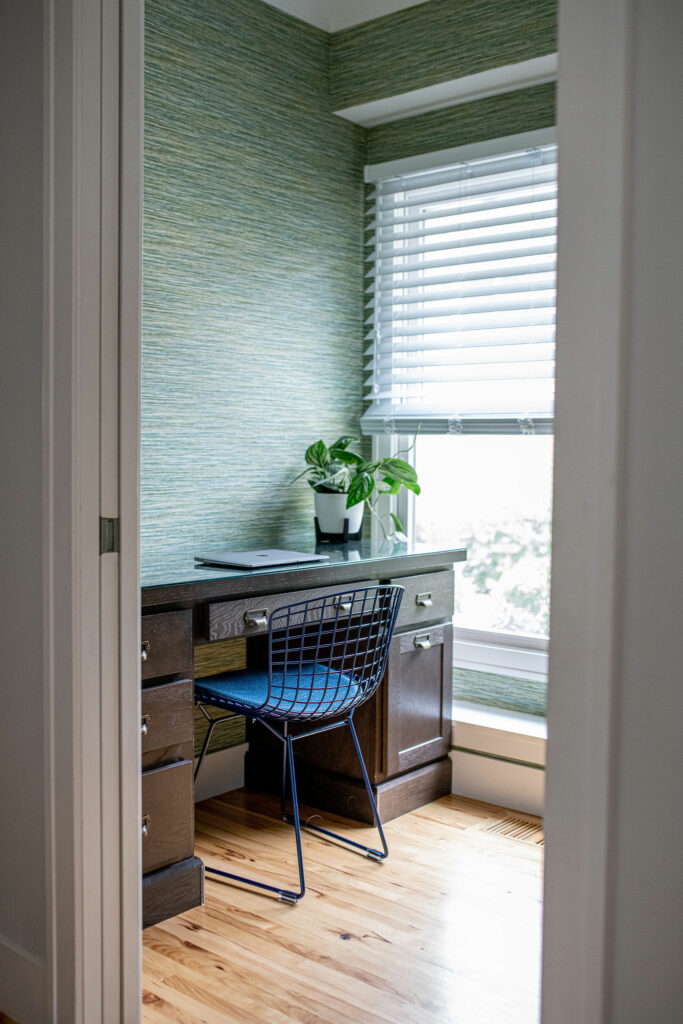 After image of Office design with colorful wallpaper, a new office chair, and faux wooden blinds. Lindsey Putzier Design Studio Hudson, OH