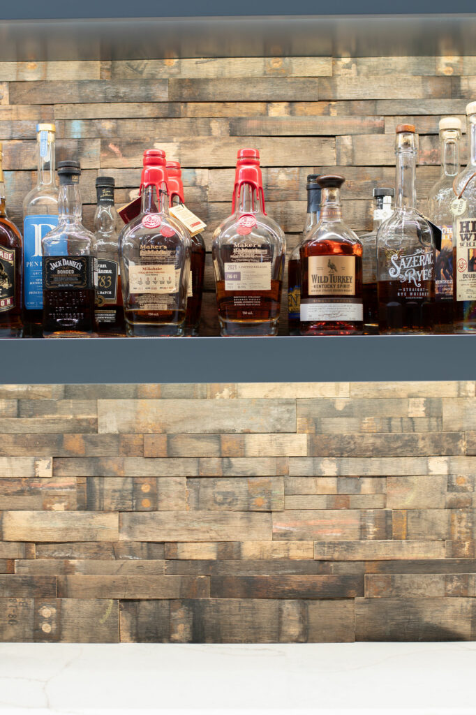 Backsplash in Whiskey Bar design made from whiskey barrels. Lindsey Putzier Design Studio Hudson, OH