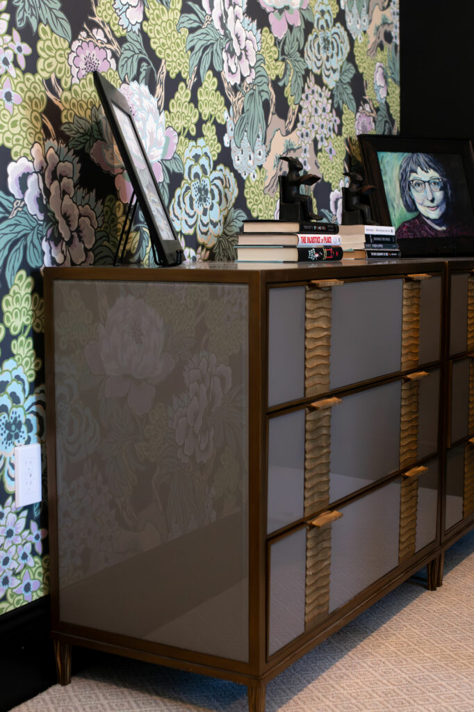 Storage chest against botanical wallpapered accent wall in Office design. Lindsey Putzier Design Studio. Hudson, OH