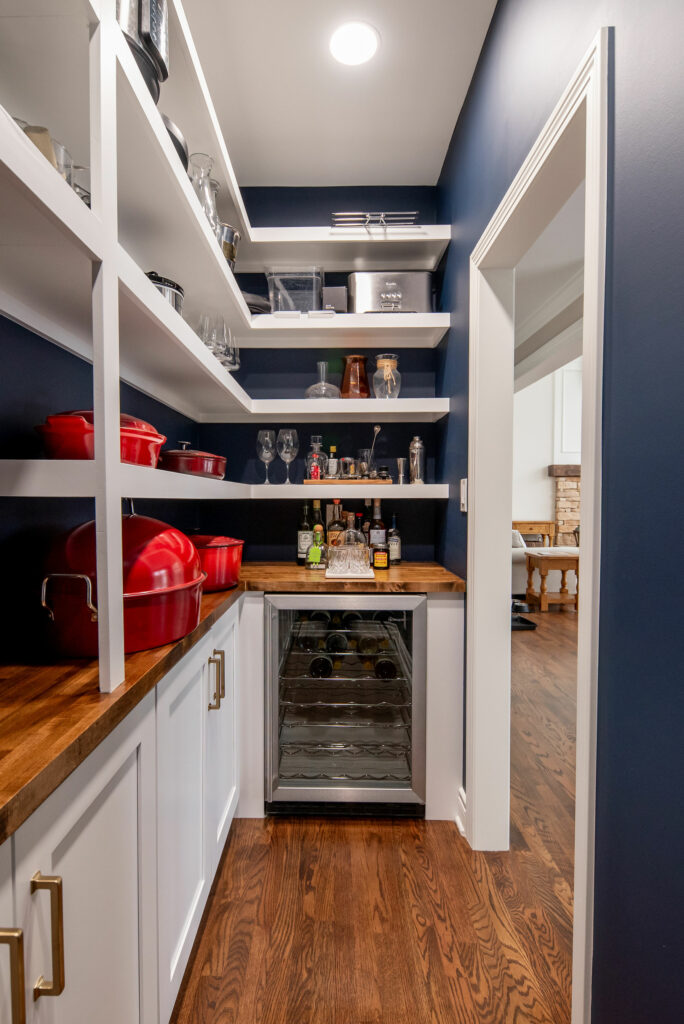 Butler's Pantry in Kitchen design with white cabinetry and deep navy back of shelf color. Lindsey Putzier Design Studio Hudson, OH