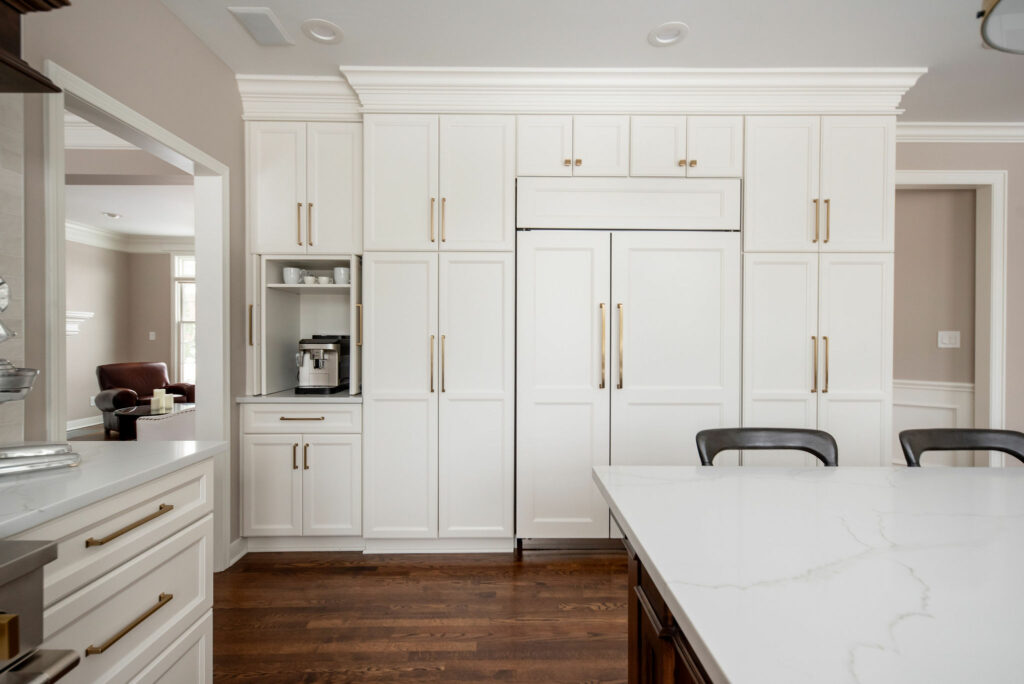 After image of fridge wall in Kitchen with paneled fridge and white cabinetry. Lindsey Putzier Design Studio Hudson, OH