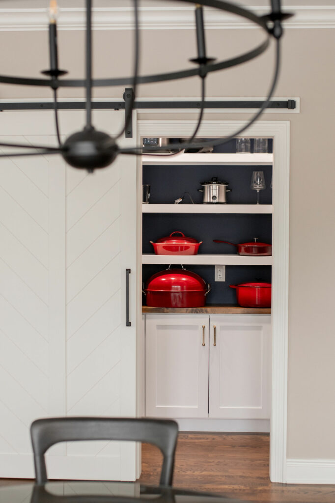 Butler's Pantry in Kitchen design with white cabinetry and deep navy back of shelf color. Lindsey Putzier Design Studio Hudson, OH