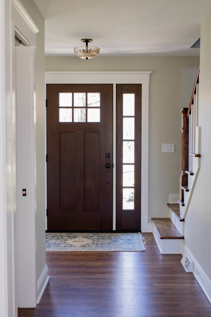 View of the new door with windows and side lights, along with the new wood floor.  Lindsey Putzier Design Studio, Hudson, Ohio