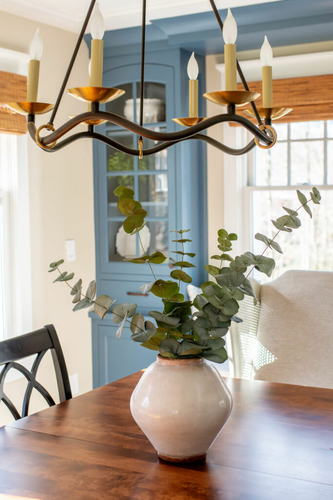 Elegant chandelier with a modern fun flair, finished in a mix of bronze and brass. Lindsey Putzier Design Studio, Hudson, Ohio
