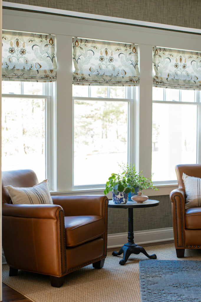 View of the custom Roman shades over three windows, behind the two leather arm chairs. Lindsey Putzier Design Studio, Hudson, Ohio
