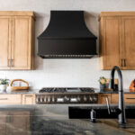 Stove and range in Kitchen between large wooden cabinets. Lindsey Putzier Interior design Stow Ohio