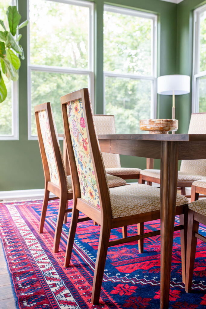 colorful patterned rug with large 6 person wooden dining room table. Lindsey Putzier interior design Hudson Ohio