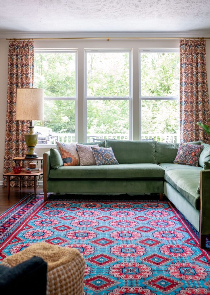 Patterned rug, large window and colorful sofa in Living room. Lindsey Putzier Interior Design Hudson, Ohio