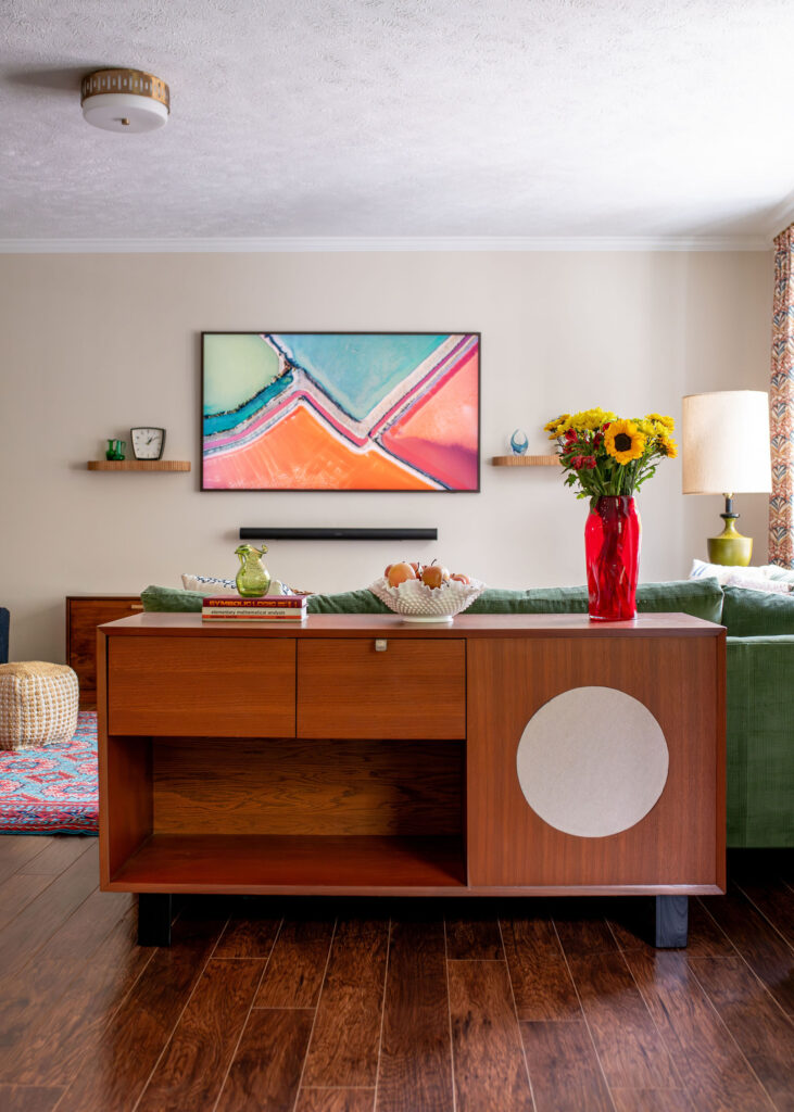 Vintage wood furniture with vase and flowers in the living room. Hudson Ohio interior design Lindsey Putzier 