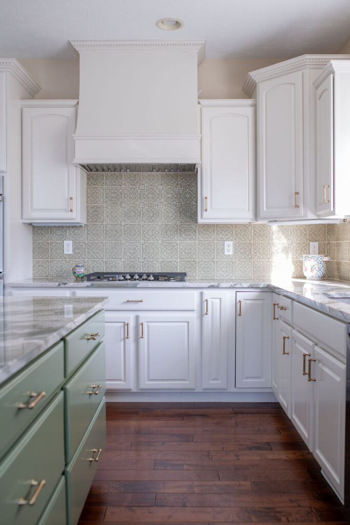 Kitchen redesign with custom creme cabinetry, large range and green textured backsplash. Lindsey Putzier interior design Hudson Ohio