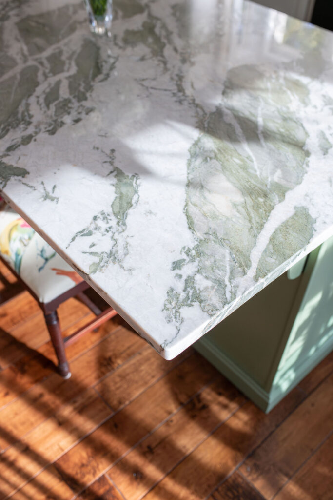 Green marble countertop in the kitchen with hardwood flooring, Lindsey Putzier interior design Hudson Ohio