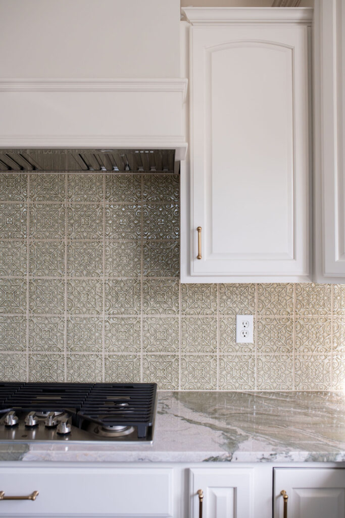 Textured backsplash refresh in the kitchen with green marble countertops. Lindsey Putzier interior design Aurora Ohio