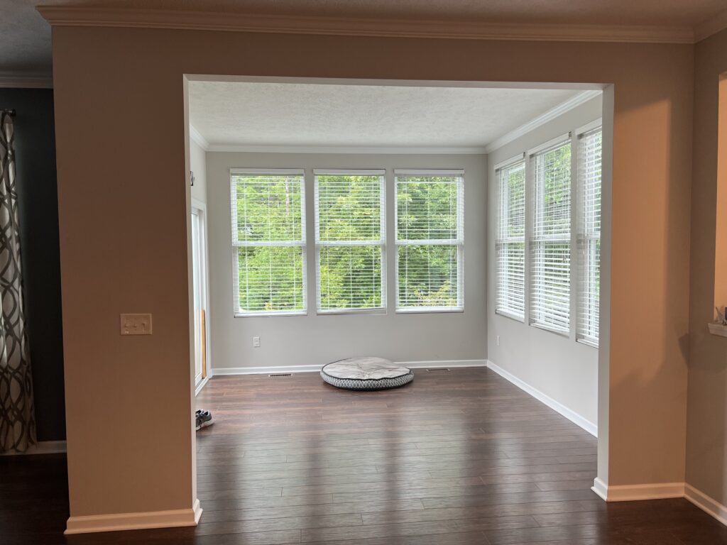 Before of the dining room with cream walls and natural lighting. Hudson Ohio interior design Lindsey Putzier. 