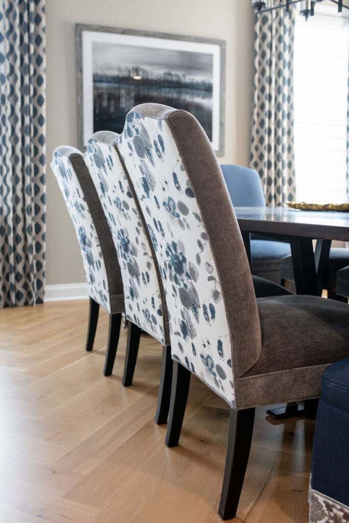Custom upholstered chairs with floral blue detail in the dining room. Brecksville Ohio interior design Lindsey Putzier