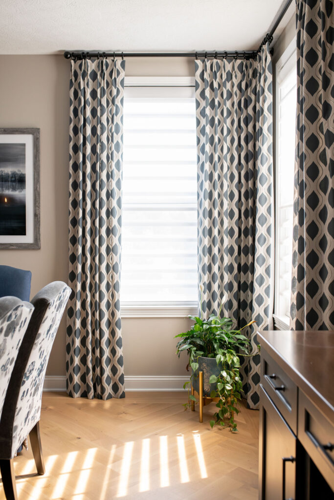 Custom patterned window treatments in the dining room with live plants. Brecksville Ohio interior design Lindsey Putzier
