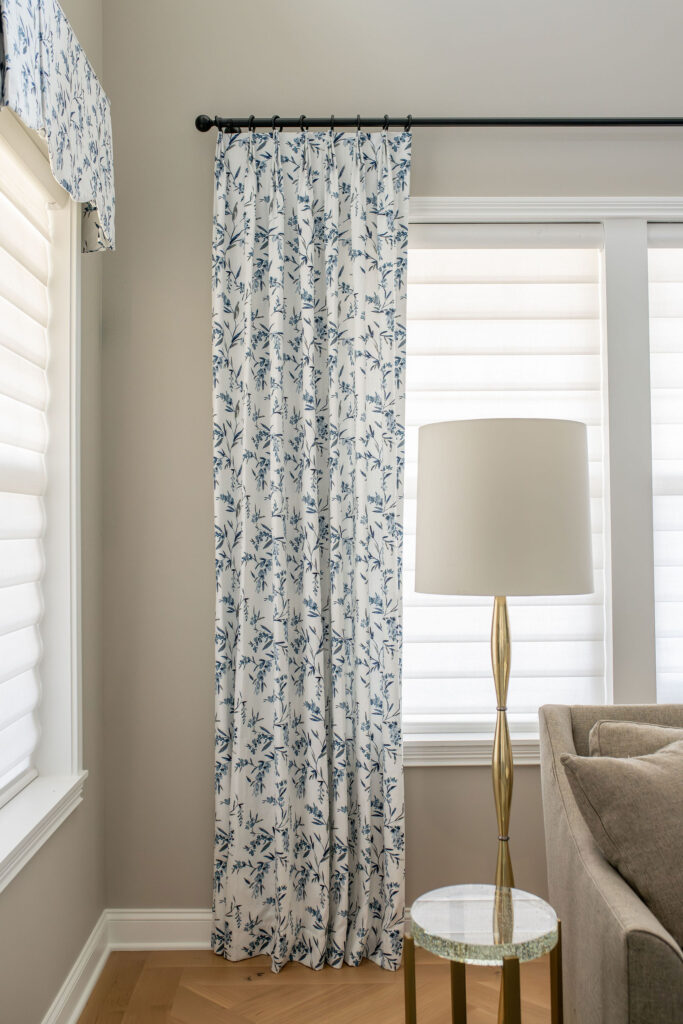 Custom window treatments with blue floral pattern in the living room. Brecksville Ohio interior design Lindsey Putzier