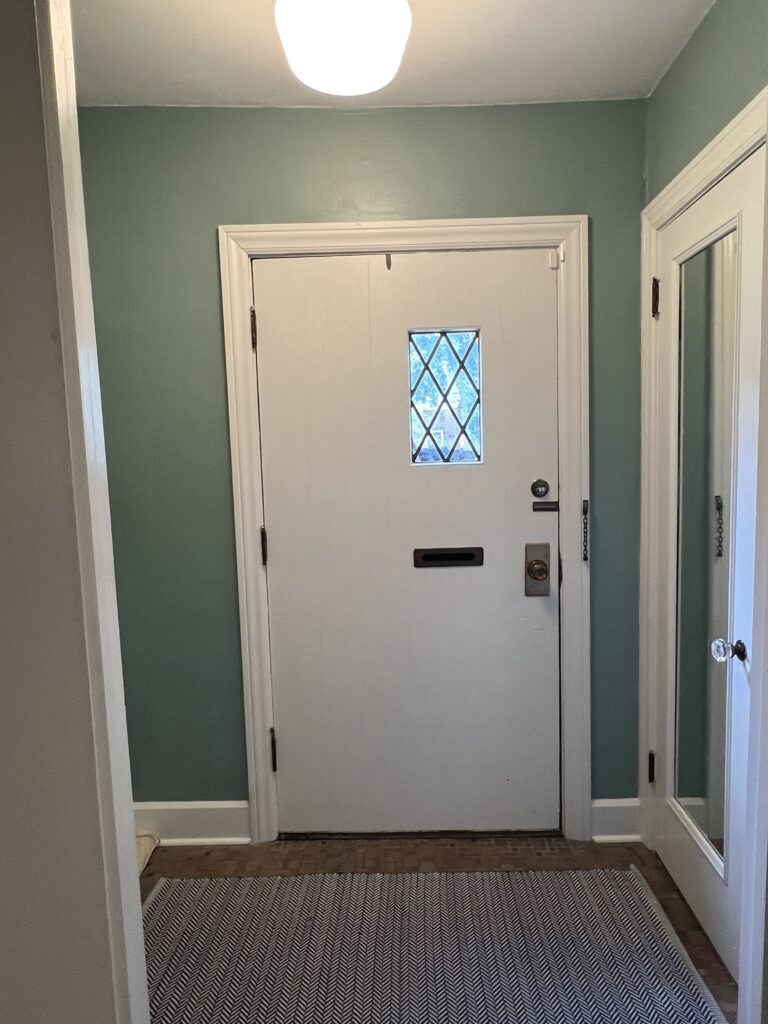 Before photo of the front vestibule Shaker Heights Ohio Lindsey Putzier interior design