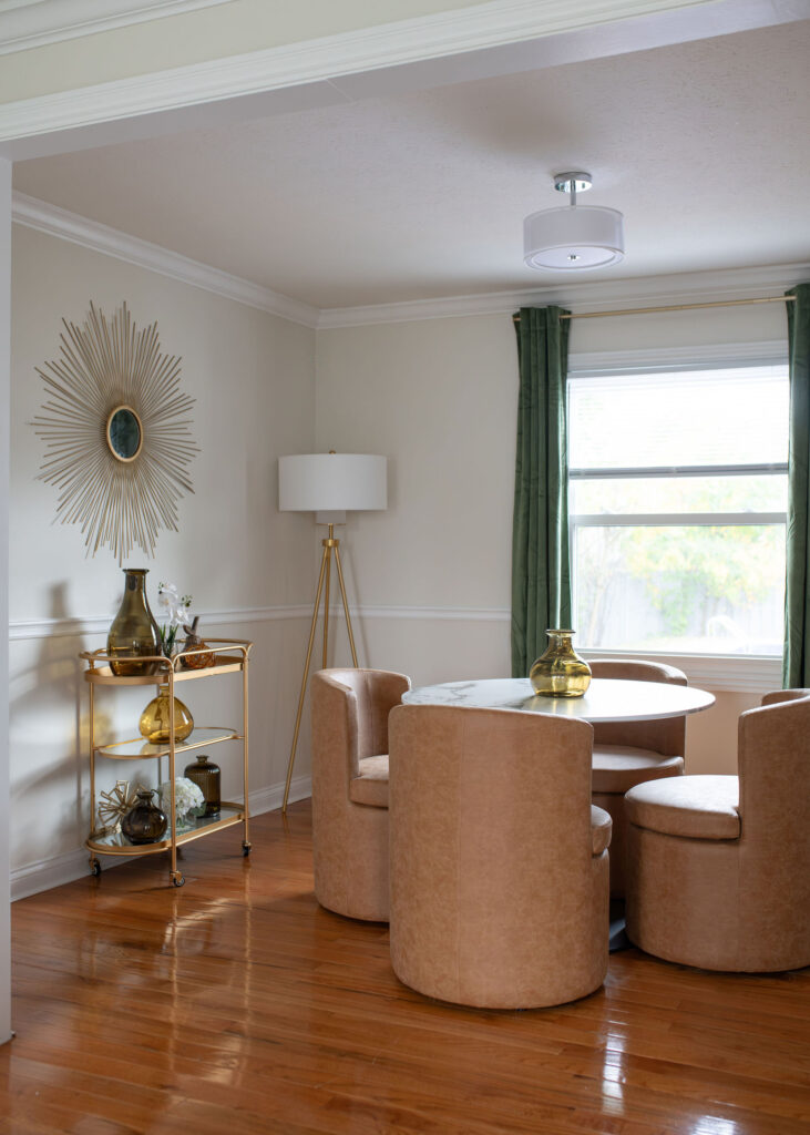 Golden bar cart and accents in the dining room. Lindsey Putzier interior design Parma Ohio