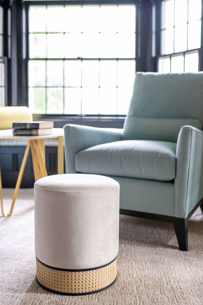 Bright blue upholstered chairs and cream foot stools in the Study. Hudson Ohio interior design Lindsey Putzier