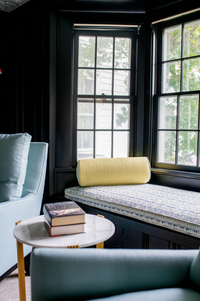 After of the window seat in the study with patterned custom upholstered seat and yellow accent pillow. Lindsey Putzier interior design Hudson Ohio
