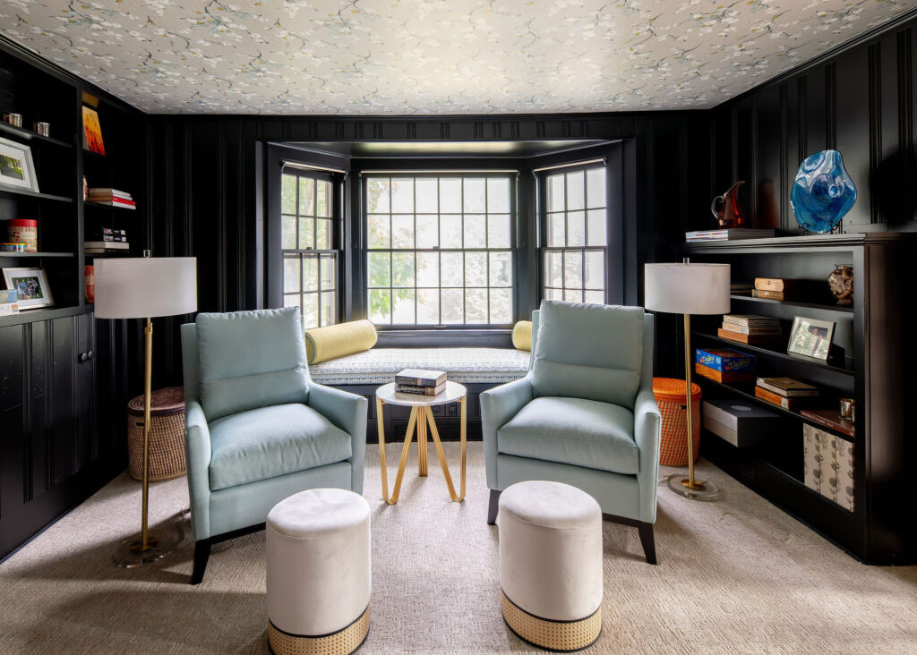 Study with dark walls, cream carpet, and bright blue accents. Hudson, Ohio interior design Lindsey Putzier