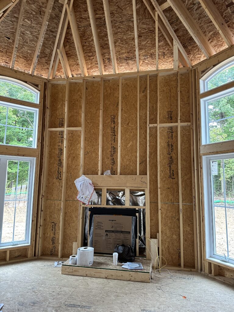 Bare bones of the fireplace in the beginning stages of construction. Chagrin Falls Ohio Interior Design Lindsey Putzier 