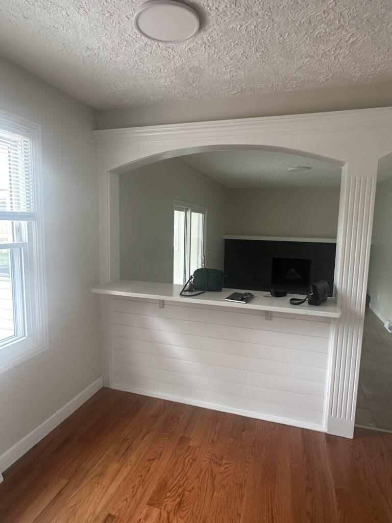 Before of the breakfast nook in Parma Ohio vacation rental with white wooden panels. Lindsey Putzier interior design