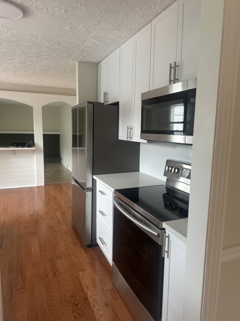 Before of the kitchen in this Parma Ohio vacation rental. Lindsey Putzier interior design