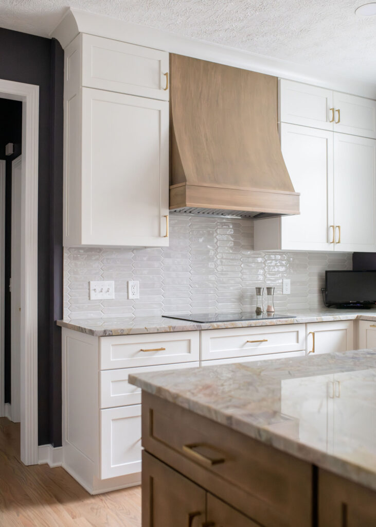 Kitchen remodel with custom built wooden range, stone countertops, and white tile backsplash. Aurora Ohio interior design Lindsey Putzier
