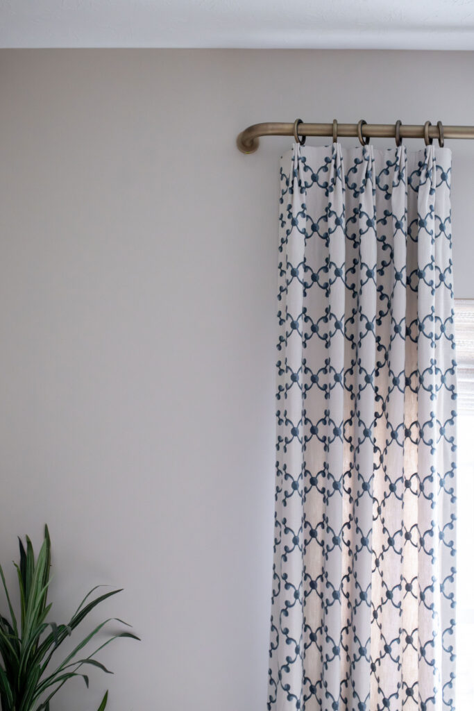 Custom window treatment in the home office with blue diamond pattern and a golden curtain rod. Lindsey Putzier interior design Peninsula Ohio