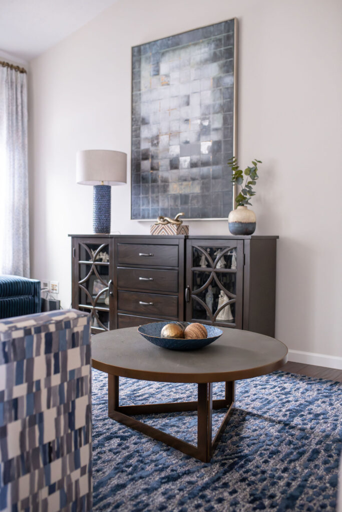 Dining room in Peninsula Ohio with dark wood finished and indigo blue patterns. Lindsey Putzier interior design 