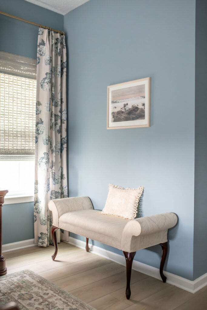 After of the master bedroom with blue colored walls and floral drapes. Lindsey Putzier interior design Peninsula Ohio