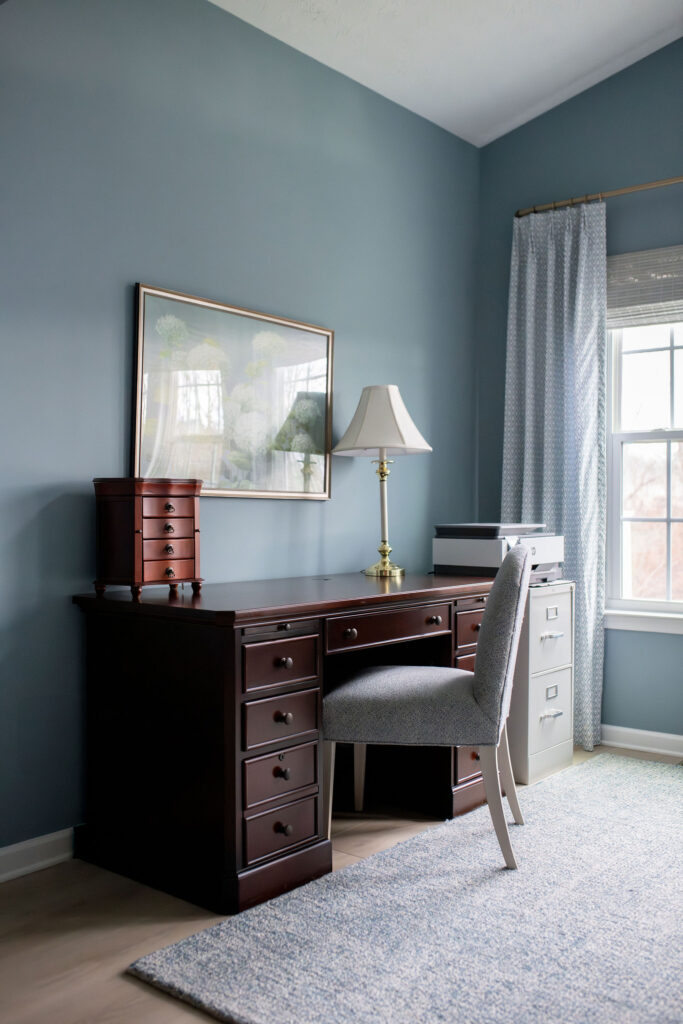 Desk in the master bedroom with blue rug and large piece of artwork. Lindsey Putzier interior design Peninsula Ohio 