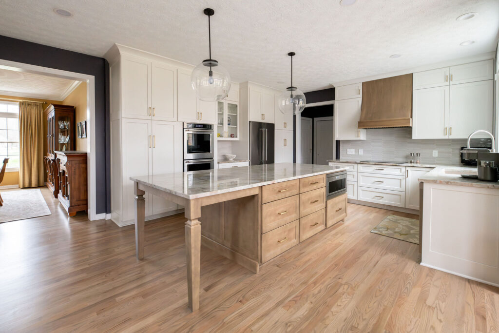 Kitchen remodel in Aurora Ohio with light cabinets, hardwood flooring and granite countertops. Lindsey Putzier interior design 